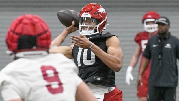 Razorbacks' quarterback Taylen Green throwing a pass in Friday practice